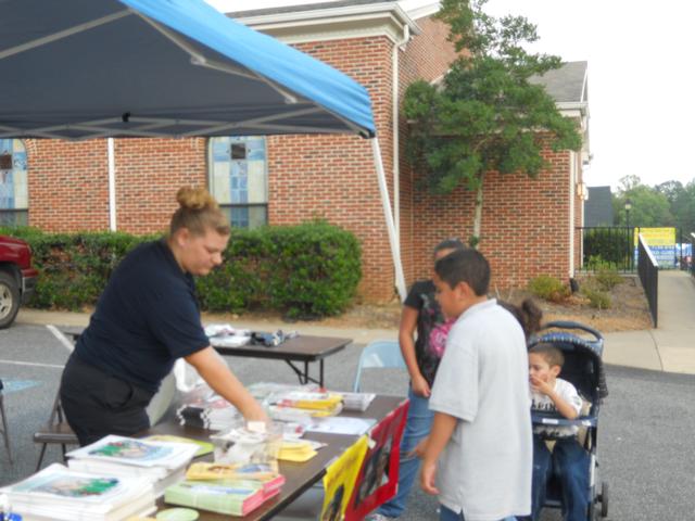 Angela Wilhelm hands out safety information to the children